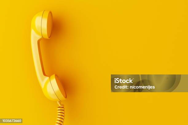 3d Phone Reciever On Yellow Background Stock Photo - Download Image Now - Telephone, Yellow, Old