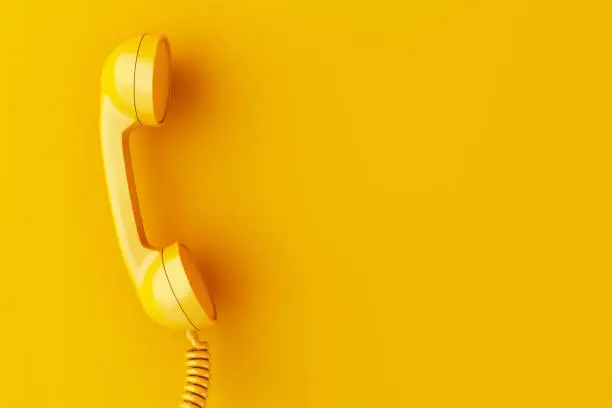 3d illustration. Vintage phone reciever on yellow background.