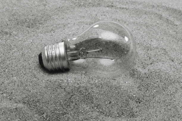 black and white effect of electric lamp on sand
