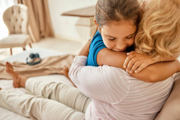 istock granddaughter hugging her grandmother 1035676102