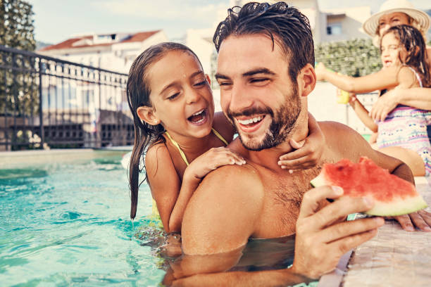 istock playful father having fun with his daughter in the pool 1035676604