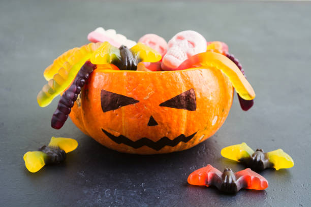 istock Halloween Jack with various Halloween candies on black background 1035678980