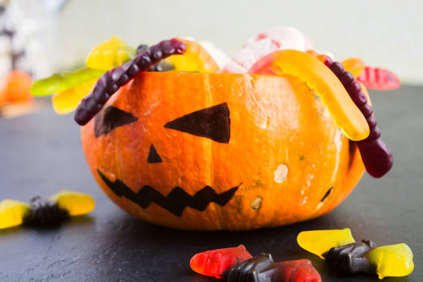 istock Trick or treat Halloween concept with pumpkin Jack with various candies 1035679072