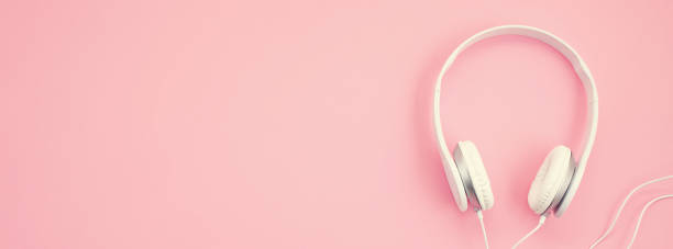 istock Banner with white earphones on pink background 1035679152