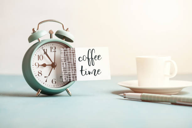istock Mockup of retro style alarm clock with empty sticky note with text Coffee time. 1035679176