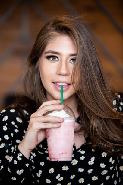 istock Young Woman taking a strawberry frappe 1035679604