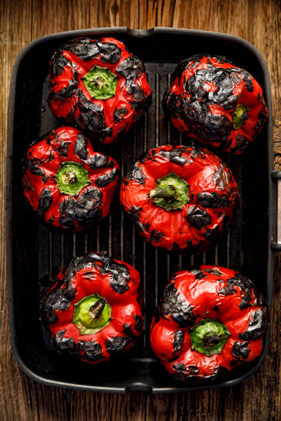 istock Roasted red bell peppers on a grill plate, top view. 1035680228