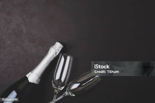 Wineglasses And Bottle Of Champagne With Serpentine Lying On Black Wooden Background New Year Celebration Concept Top View Flat Lay Toned Stock Photo - Download Image Now