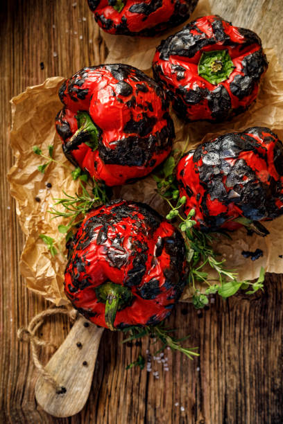 istock Grilled red peppers with fresh herbs on a wooden table. 1035689132
