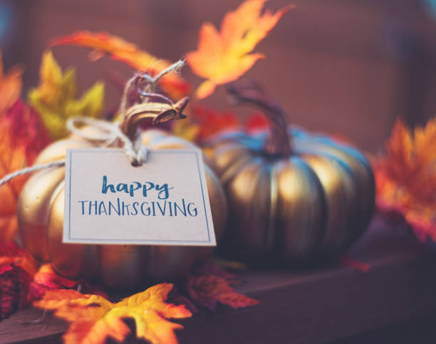 Thanksgiving background with metallic pumpkin, greeting and leaves