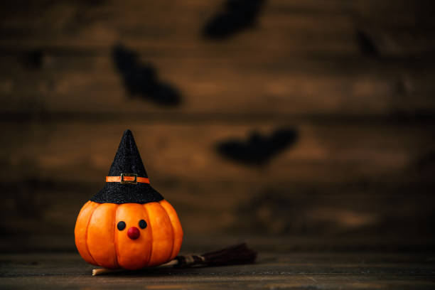 istock Little pumpkin witch with bats for Halloween 1035699472