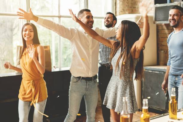istock Enjoying party with best friends. Cheerful young people dancing and drinking while enjoying home party on the kitchen. 1035707464