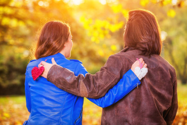 istock Couple holding heart-shape on a bench in the park. 1035708382