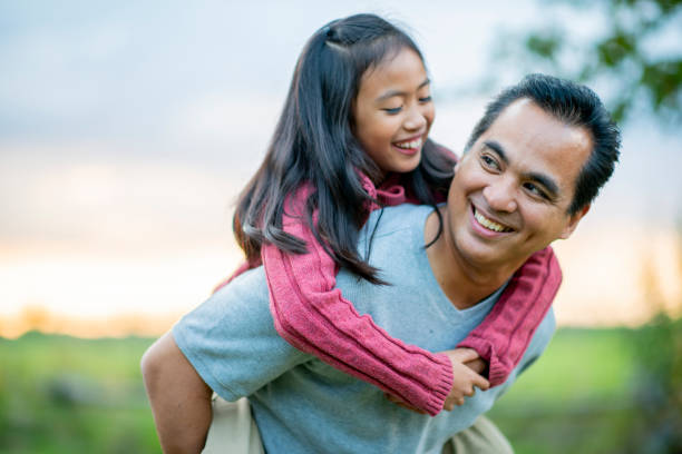 istock Father gives his daughter a piggyback ride 1035719154