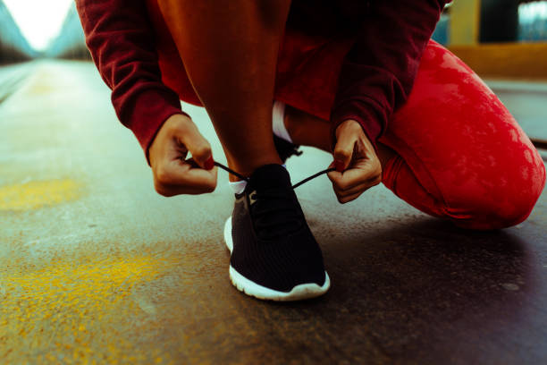 istock Female tying running shoes 1035719446
