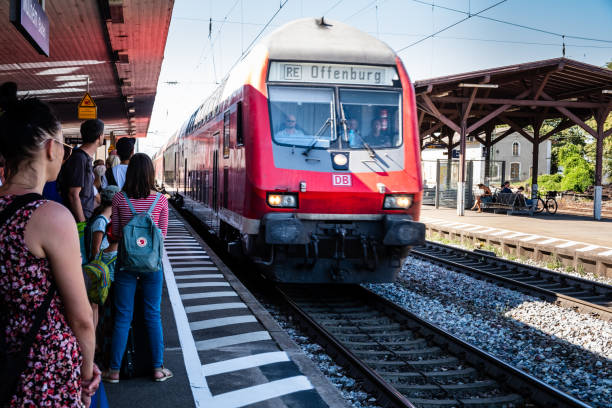 Regional train to Offenburg in Mullheim station Mullheim, Baden-Wurttemberg, Germany - JULY 30 2018 : DB Regional train from Basel (Switzerland) to Offenburg (Germany) arriving at the Mullheim station while passengers are waiting on the platform deutsche bahn stock pictures, royalty-free photos & images