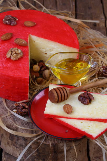 istock Still life with cheese, honey and nuts on a wooden table 1035725044