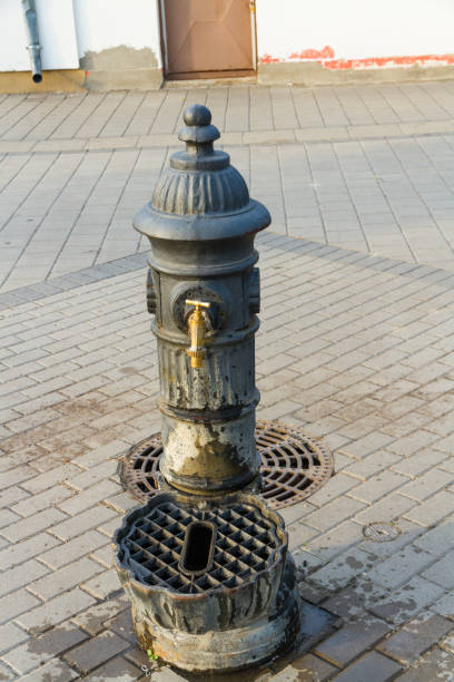 istock Old public water tap or faucet in sunlight. 1035729154