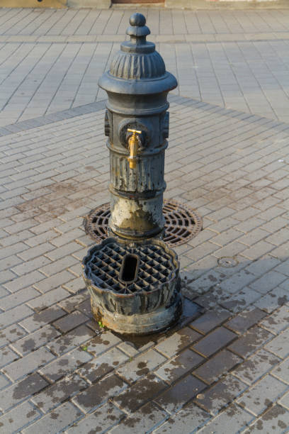 istock Old public water tap or faucet in sunlight. 1035729226