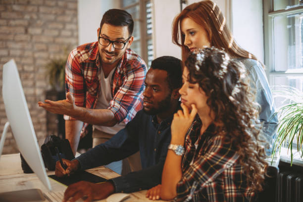 istock Young group of designers negotiates about design 1035739492