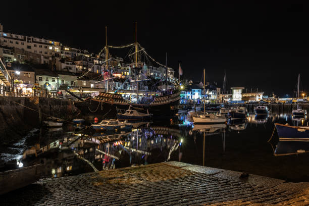 istock Boats in the harbour at night in Brixham, Devon 1035743030