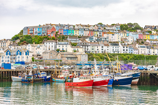 The fishing port of Brixham, Devon with a row of trawler boats.
