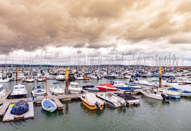 istock Dramatic sky over that boats in the harbour in Brixham, Devon 1035745094