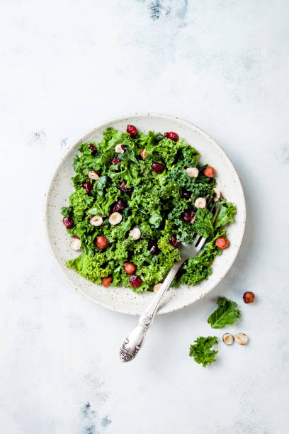 istock Kale salad with dried cranberry, hazelnuts and olive oil 1035745184