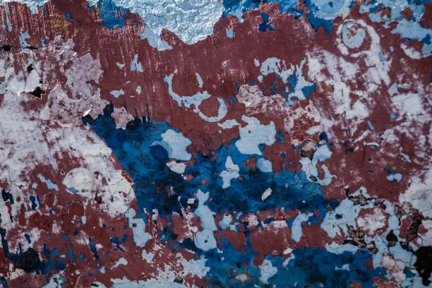 Old blue and red cracked wall background, grungy texture pattern