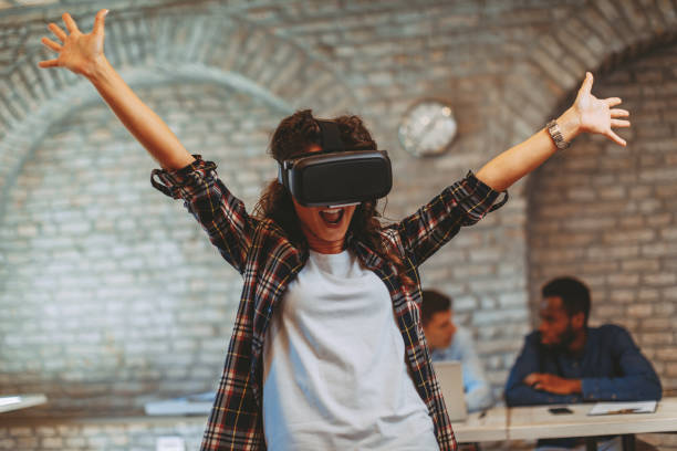 istock Young woman have fun with Virtual Reality VR Headset BOX in the office 1035748140