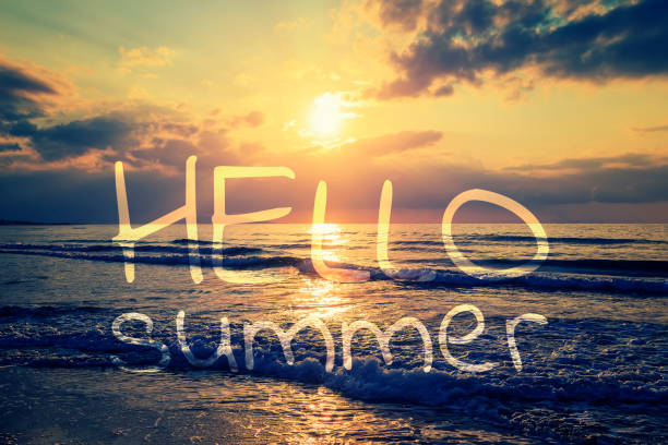 istock Hello summer card. Calligraphy lettering on romantic evening and magic sunset on sandy beach of Crete, Greece. Walk on the beach during beautiful sunset. 1035751444