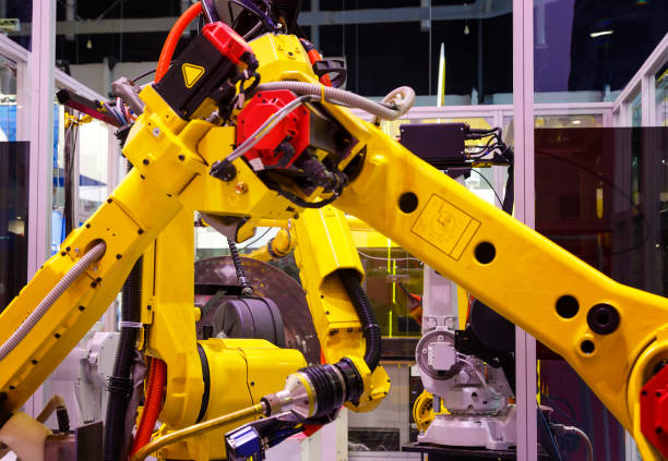 istock yellow robots process metal parts in a production line 1035751576