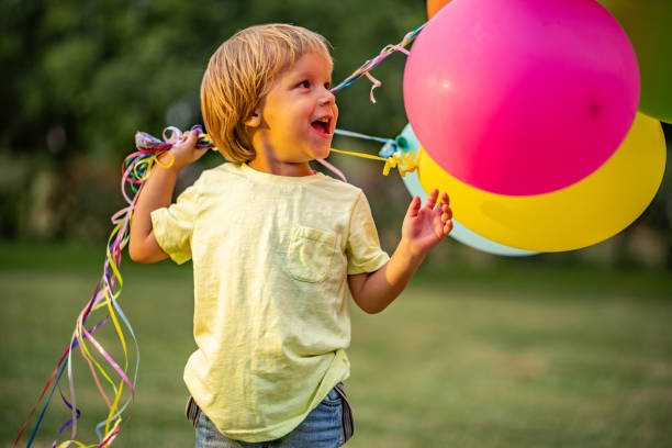 istock Beauty little boy with a multi colored balloons 1035761384