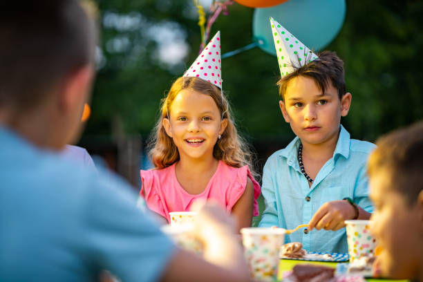 istock Boy and girl eating birthday cake 1035762132