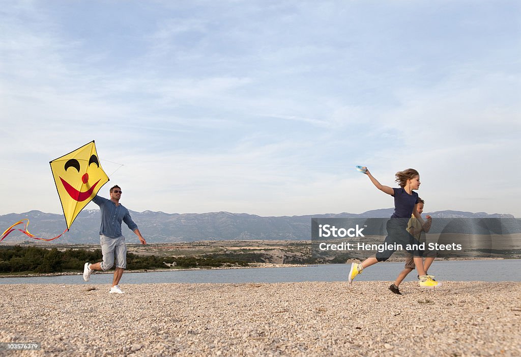 Father and children with kite at beach Croatia Kite - Toy Stock Photo