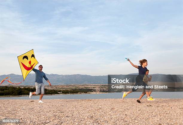 Father And Children With Kite At Beach Stock Photo - Download Image Now - Kite - Toy, Family, Flying