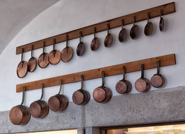 istock Kitchen utensils and tableware on shelf. Group of stainless steel kitchenware. 1035765472