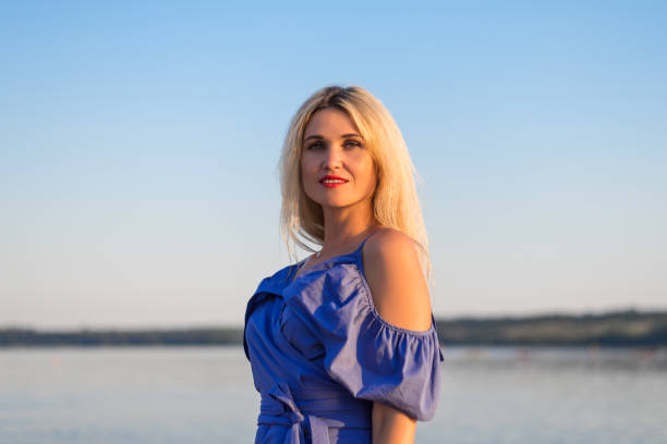 istock Beautiful young woman on the river bank. 1035772000