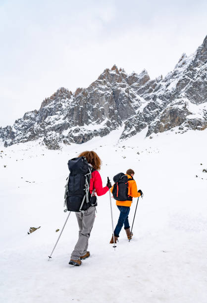 istock Couple hiking in the snow mountains 1035774980