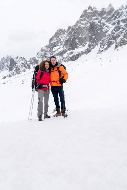 istock Happy couple trekking in the snow 1035775016
