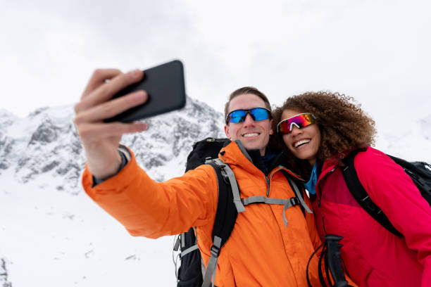 istock Happy couple taking a selfie while trekking in the snow 1035775116