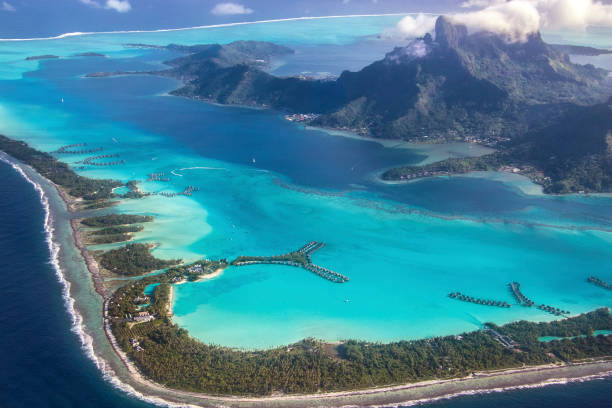 Over Bora Bora The amazing view flying into Bora Bora. French Polynesia, South Pacific Ocean. bora bora mountain stock pictures, royalty-free photos & images
