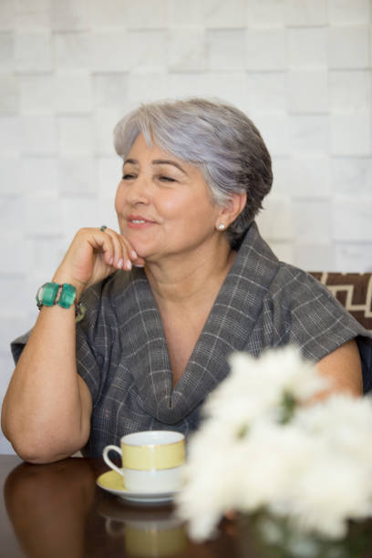 istock Elderly Brazilian woman having tea or coffee. 1035783408