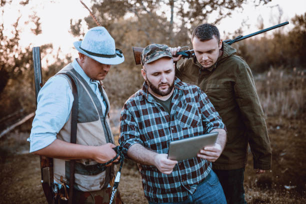 istock Group of Hunters Looking for GPS Coordinates on Tablet in Nature 1035783454