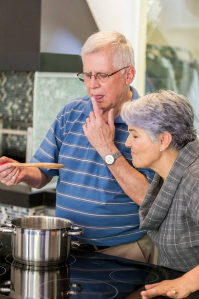 istock Brazilian elderly couple cooking together. 1035788402