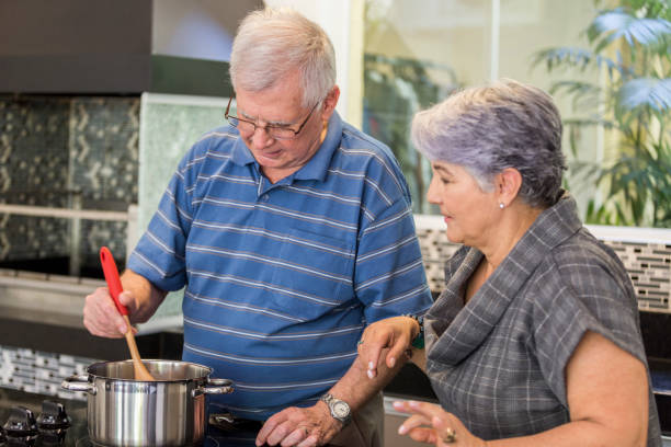 istock Brazilian elderly couple cooking together. 1035788452