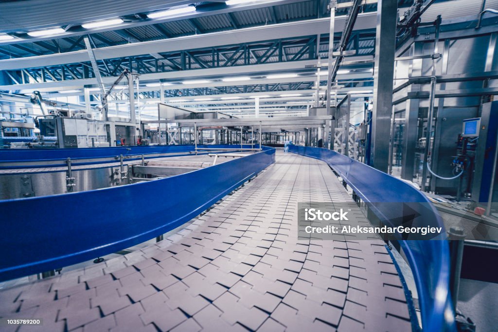 Big Production Line Track In Water Bottling Plant Industry Stock Photo