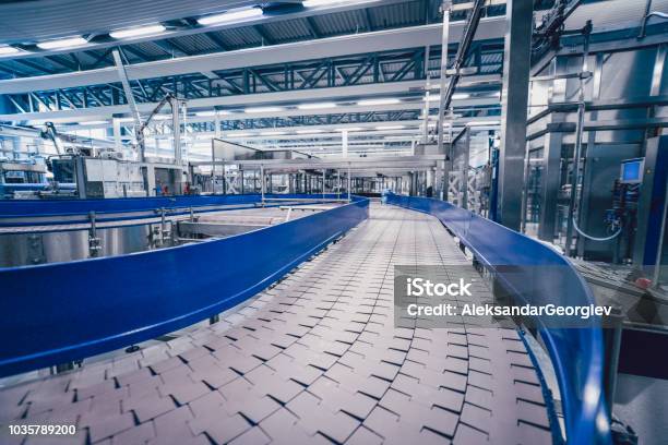 Big Production Line Track In Water Bottling Plant Stock Photo - Download Image Now - Industry, Machinery, Plastic