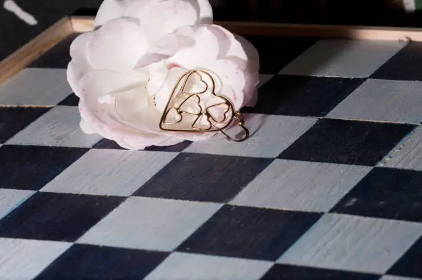 a flower with love symbol on a chess board