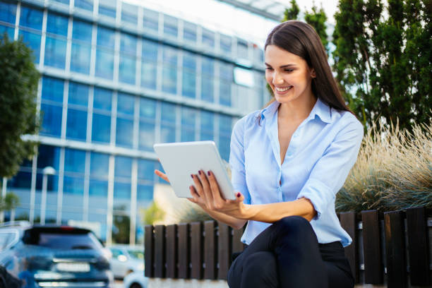 istock Businesswoman using digital tablet outdoors 1035801608